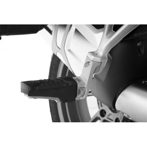 Passenger footrest relocation